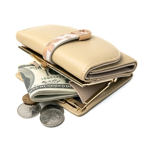 Close-up of beige lychee leather wallet featuring floral strap and golden metal clasp
