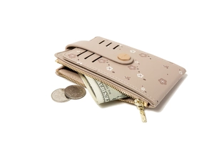 Detail view of floral print wallet with accordion slots and gold zipper closure