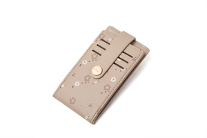 Detail view of a floral printed card holder featuring multiple slots and metal snap closure