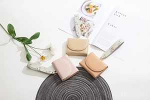 Three compact PU leather wallets with floral wristlets in beige, pink, and tan tones