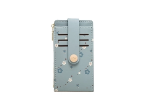 Close-up of light blue floral faux leather card holder with gold snap button and card slots