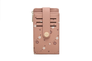 Detail of a dusty rose floral card holder with three slots, snap button, and side zipper