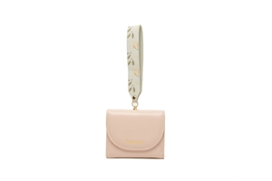 Pink short wallet with floral wrist strap and gold logo detail on smooth leather