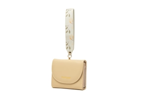 Detail view of a tri-fold beige PU leather wallet with a floral printed wristlet strap