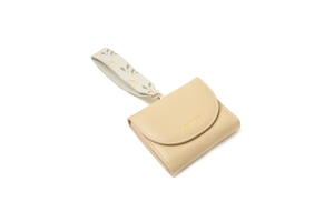 Close-up of beige trifold wallet featuring a floral wristlet strap and gold hardware