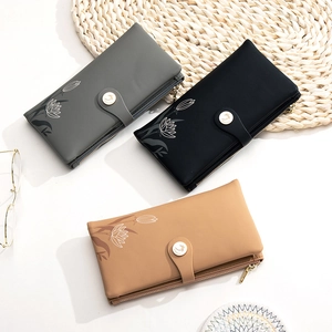 Flat lay of floral PU leather wallets in gray, black, and camel with snap closure