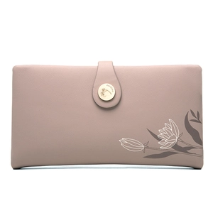 Detail of rose pink long wallet featuring floral print and branded gold snap button