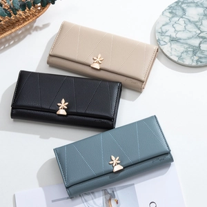 Three long leather wallets with V-shaped stitching and golden leaf-shaped metal clasps