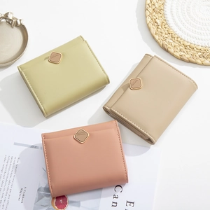 Minimalist tri-fold short wallets in green, apricot, and pink leather with gold buckle