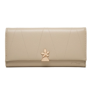 Women's long beige wallet with star pattern quilting and golden floral magnetic clasp