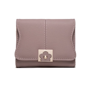 Close-up of pink PU leather wallet featuring wavy flap edge and daisy floral metal clasp