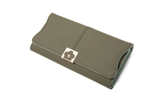 Detail of olive green leather wallet featuring a gold flower-shaped magnetic clasp closure