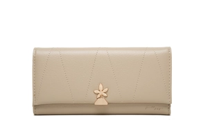 Detail of light khaki long wallet featuring V-quilted stitching and gold flower hardware