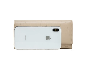 Long faux leather wallet with V-shaped stitching shown next to an iPhone for size comparison