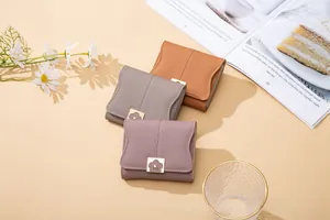 Detailed view of PU leather wallets with elegant floral gold metal clasp and stitching