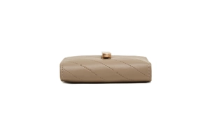 Detail of taupe quilted PU leather wallet featuring a gold buckle and Phoenix logo