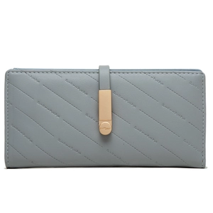 Detail of grey-blue quilted long wallet with elegant gold buckle and refined texture