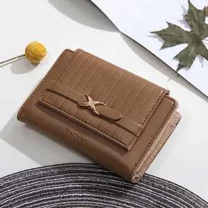 Detail of brown PU leather trifold wallet featuring vertical stripes and a gold metal buckle