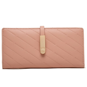 Detail of pink faux leather wallet with quilted texture and gold metal buckle closure
