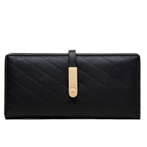 Detail of black quilted leather long wallet with golden buckle and fine stitching