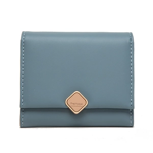 Detail of blue trifold wallet featuring golden metal buckle and neat white stitching