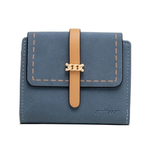 Detail of blue-grey suede-like wallet with brown strap, gold chain, and contrast stitching