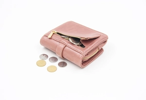 Detail of short fold-over purse showing zipper pocket for coins in dusty pink faux leather