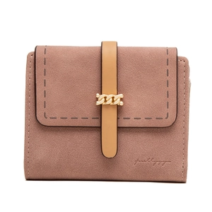 Detail of pink matte leather short wallet with gold chain clasp and precision stitching