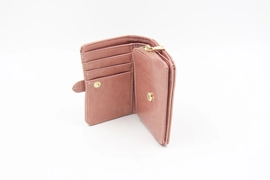 Detail view of pink trifold wallet interior with card slots and golden zipper compartment