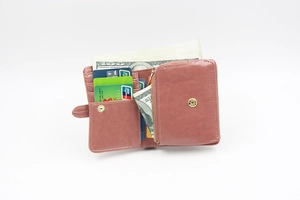 Detail view of pink oil wax leather wallet with multiple card slots and coin pocket