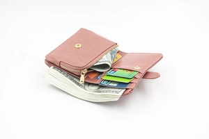 Detail showing pink faux leather wallet interior with multiple card slots and zipper pocket