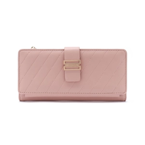 Detail of dusty rose quilted wallet featuring golden buckle and brand name texture