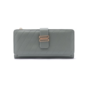 Macro detail of grey-blue long wallet featuring diagonal quilting and rose gold buckle