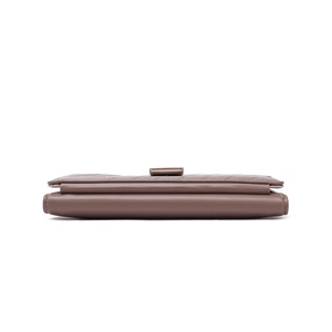 Detail view of mocha brown pleated leather clutch showing multi-layer fold structure
