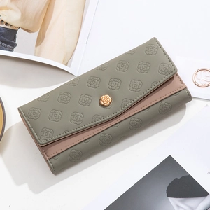 Close-up of camellia embossed long wallet with golden flower buckle in green and pink