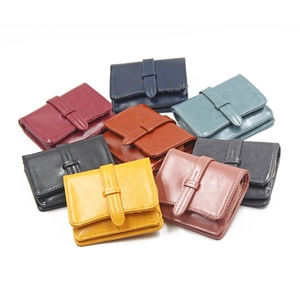 Short tri-fold multi-color leather wallets with belt closure and zipper pocket