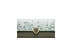 Close-up of trifold long wallet with eucalyptus pattern and golden metal magnetic buckle
