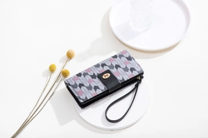 Detailed view of long zip wallet with grey herringbone pattern and gold metal logo