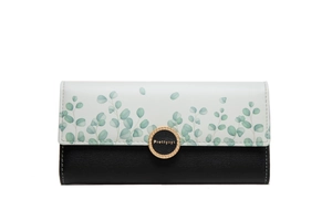 Close-up of three-fold wallet with floral print, black leather and gold buckle
