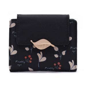 Détail d'un portefeuille court pour femme avec imprimé feuilles et décoration dorée