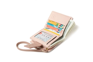 Pink multi-functional folding wallet detail with card slots and detachable wristlet