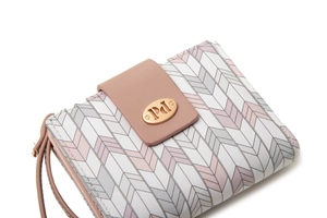 Detail of geometric pattern on women's short wallet with pink clasp and gold metal hardware
