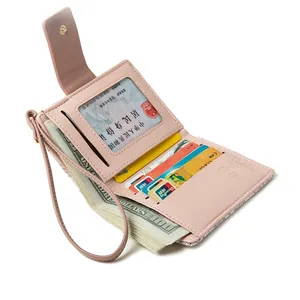 Pink PU leather folding wallet featuring multiple card slots and a convenient wristlet strap