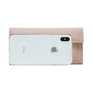 Detail of long pale pink wallet showing fine texture and iPhone size reference