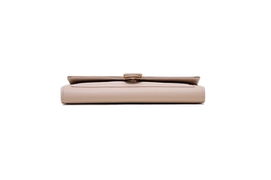 Detailed side view of light pink leather wallet with signature snake head metal buckle