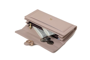 Detail of pink tri-fold long wallet interior with card slots and golden ring clasp
