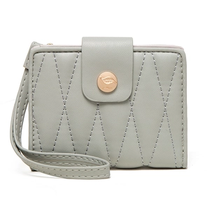 Detail of grey-green quilted PU leather wallet with gold leaf buckle and wrist strap