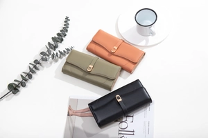 Three elegant long leather wallets in brown, olive green, and black with metal buckles