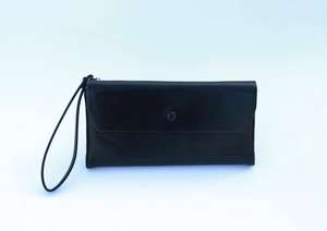 Detail of black vintage oil wax leather long wallet with buckle closure and wristlet strap