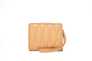 Detail of light brown quilted PU leather wallet with stitching and wrist strap